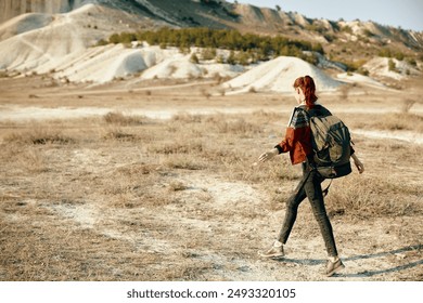 solitary hiker exploring vast desert landscape with majestic mountains in the distance - Powered by Shutterstock