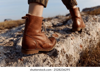 Solitary journey brown boots resting on large rock in field inspiration for adventure and travel exploration - Powered by Shutterstock