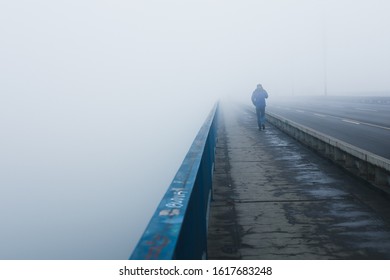 Solitary Man Walking On The Branko's Bridge Covered In Fog From Air Pollution, Belgrade Serbia, January 2020