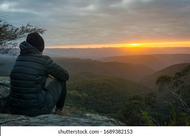 Solitary Person Sitting And Enjoying The Sunrise From Splendour Rock, Blue Mountains, NSW, Australia