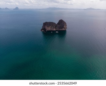 A solitary rock island stands amid the vast ocean waters. - Powered by Shutterstock