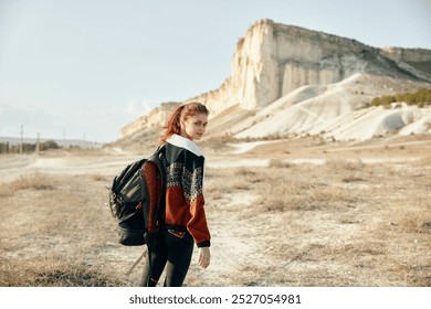 solitary traveler pauses to admire desert landscape with majestic mountains in the distance - Powered by Shutterstock