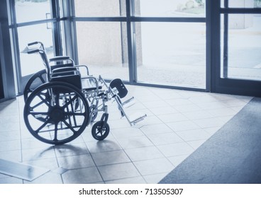 solitary wheelchair resting in the lobby of a hospital. Abstract healthcare and disability image - Powered by Shutterstock