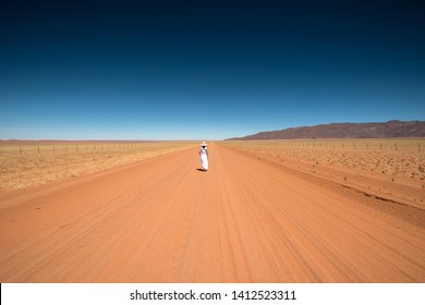 Solitary Woman In The Namibian Desert