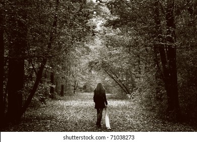Solitude concept - lonely sad woman in the woods