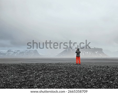 Solitude and exploration concept with a figure in a desolate volcanic landscape in Iceland