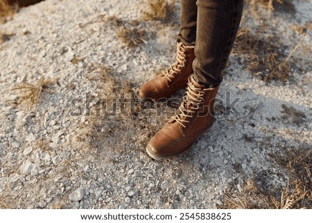 solitude on the summit lone figure in jeans and boots gazes down from hilltop