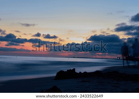 Solitude in Sunset: A Figure Stands Tall on the Golden Shore