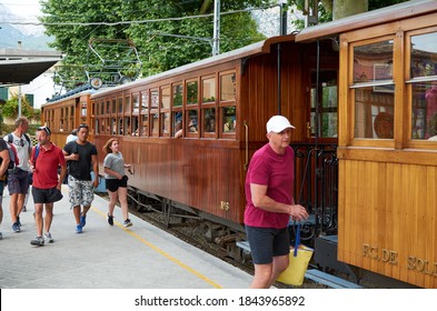 Soller, Mallorca, Spain - May 21, 2017: People Getting On The Soller Train. Old Wooden Train