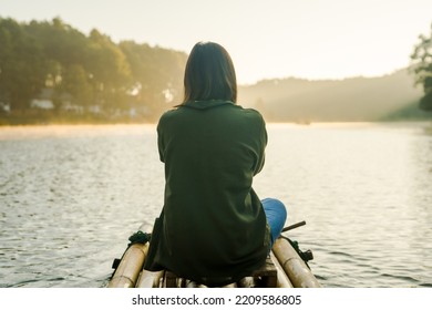 Solo Asian Woman Travel By Thai Local Bamboo Boat In Tropical Forest And Lake In Autumn Season