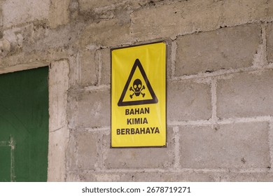 Solo, Central Java, Indonesia - September 17, 2025: Hazardous Chemical Warning Sign on Concrete Wall in Industrial Area