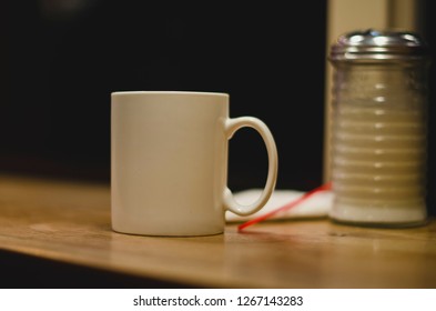 The Solo Coffee Mug In The Late Night Diner As The Lights Glow. 