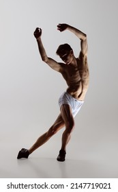 Solo. Express Feelings By Movements. Contemp Dance, Performance. Young Flexible Shirtless Man In Underwear Dancing Isolated On Gray Background. Art, Music, Beauty. Healthy Lifestyle Concept