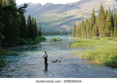 Solo fly fisherman in waders in the middle of the river - Powered by Shutterstock