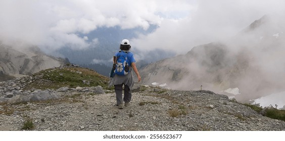 Solo Hiker Exploring Misty Mountain Trails - Powered by Shutterstock