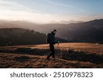 Solo Hiker Walking at Sunset on Mountain Ridge