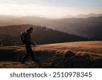 Solo Hiker Walking at Sunset on Mountain Ridge