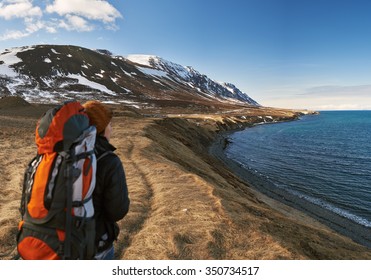 Solo Independent Traveler On Active Holiday, Hiking Trekking In Beautiful Natural Outdoor Landscape By The Ocean And Mountains