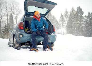 Solo Indian Man Traveller Camping Through An Evergreen Winter Forest In Canada