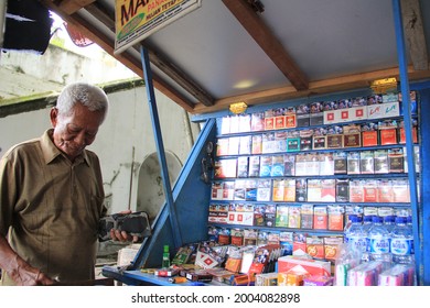 Solo, Indonesia - December 10, 2017: Old Man Selling Cigarettes By The Roadside