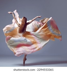 Solo performance. Ballerina wearing rainbow dress dancing graceful movement over grey studio background. Beauty of contemporary dance. Art, motion, action, flexibility, inspiration concept - Powered by Shutterstock