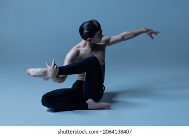 Solo performance. Young and graceful man, male ballet dancer isolated on old navy studio background. Art, motion, action, inspiration concept. Flexible artist in stage costume. Beauty of male body
