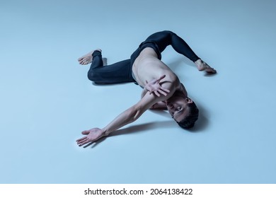 Solo Performance. Young And Graceful Man, Male Ballet Dancer Isolated On Old Navy Studio Background. Art, Motion, Action, Inspiration Concept. Flexible Artist In Stage Costume. Beauty Of Male Body