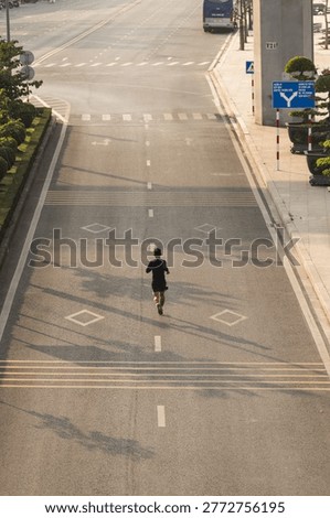 Solo Runner on an Empty Road at Sunrise High Angle View