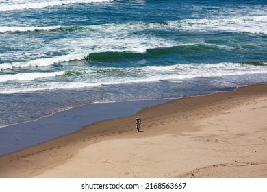 Solo Traveler Walking Along The Beach