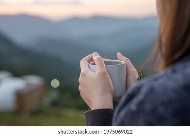 solo woman drink coffee with relax and wellbeing feel with mountain background - Shutterstock ID 1975069022