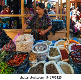 SOLOLA, GUATEMALA - MARCH 22 2013: The typical products being sold on local markets in Guatemala. A local and colorful saleswomen at work. 