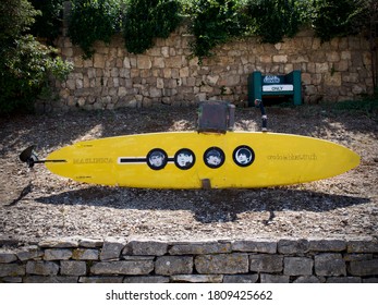 Solta, Croatia September 2020. A replica of the famous yellow submarine, named after the famous Beatles song, an art sculpture made of a surfboard, standing in the port welcoming tourists