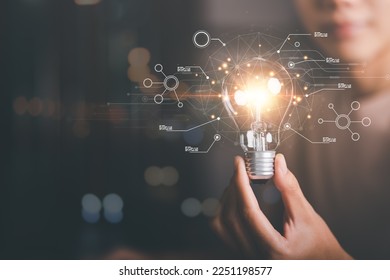 solution concept and demonstrating leadership strategies,that lead the business in a successful direction,with innovation and brain power from brainstorming,light bulb in human hand - Shutterstock ID 2251198577