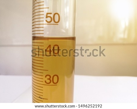The solution in the measuring cylinder is read by 45 milliliters. Reading scientific instruments. Laboratory measurements.