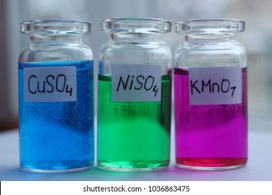 Solutions Of Copper Sulfate,nickel Sulfate And Potassium Permanganate In The Glass Jars.