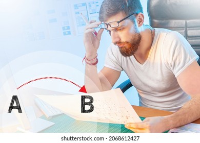 Solving problems during work. Designer thinks about solving problem. Man designer works in office. He solves some problem. Letters A and B as a metaphor for solving problems. Working as a designer