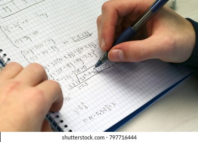 Solving a system equation in high school. Closeup view. 