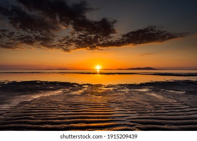 Solway Beach Sunset, Orange Warming Sun Setting On The Cumbria Coast With The Beautiful Sands