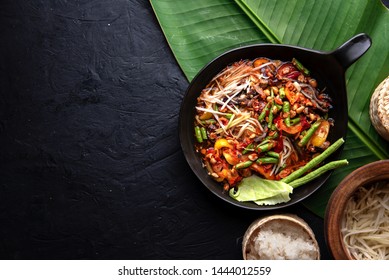 Som Tam Thai - Thai Green Papaya Salad And Sticky Rice Over Banana Leaf On Dark Background. Top View.