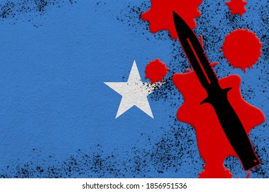 Somalia Flag And Black Tactical Knife In Red Blood. Concept For Terror Attack Or Military Operations With Lethal Outcome