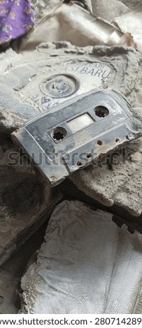 A somber, post-disaster atmosphere filled with the remnants of the volcanic eruption.