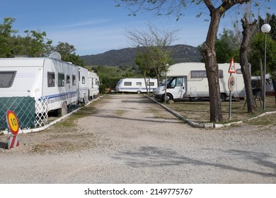 Some Caravans, Rv And Mobile Homes Parked In A Camping To Spend The Night