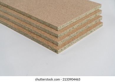 Some chipboard building boards on a white background with copy space  - Shutterstock ID 2133904463