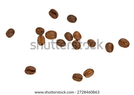 some coffee beans falling isolated on white