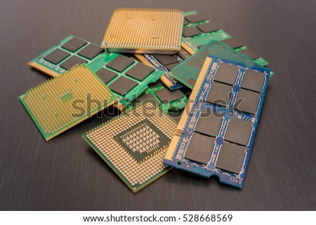 Some CPUs, and notepadnotebook RAMs on a dark grey background