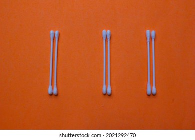 Some Ear Cleaners Or Cotton Buds Made Of Plastic Stalks And The Ends Are Fine Fibers With An Orange Background