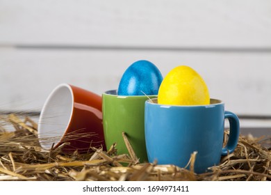 
Some Easter eggs in coffee cups. Easter, holidays and traditions concept.