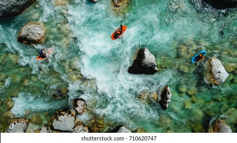 Some extreme whitewater Kayaker paddling on the Emerald waters of Soca river, Slovenia, are the rafting paradise for adrenaline seekers and also nature lovers, aerial view.