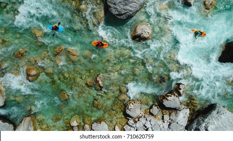 Some extreme whitewater Kayaker paddling on the Emerald waters of Soca river, Slovenia, are the rafting paradise for adrenaline seekers and also nature lovers, aerial view.
