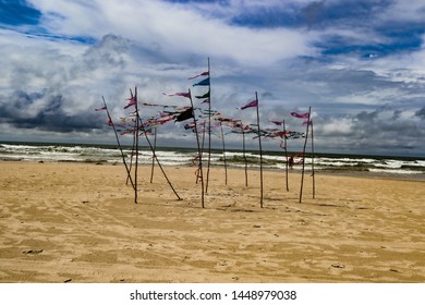 Some Flags On A Sandy Beach